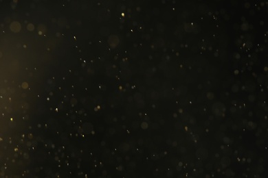 Magic golden bokeh effect on dark background