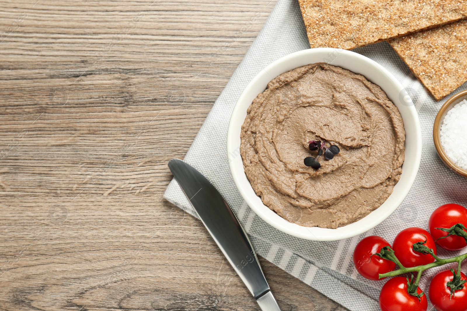 Photo of Flat lay composition with tasty liver pate on wooden table. Space for text