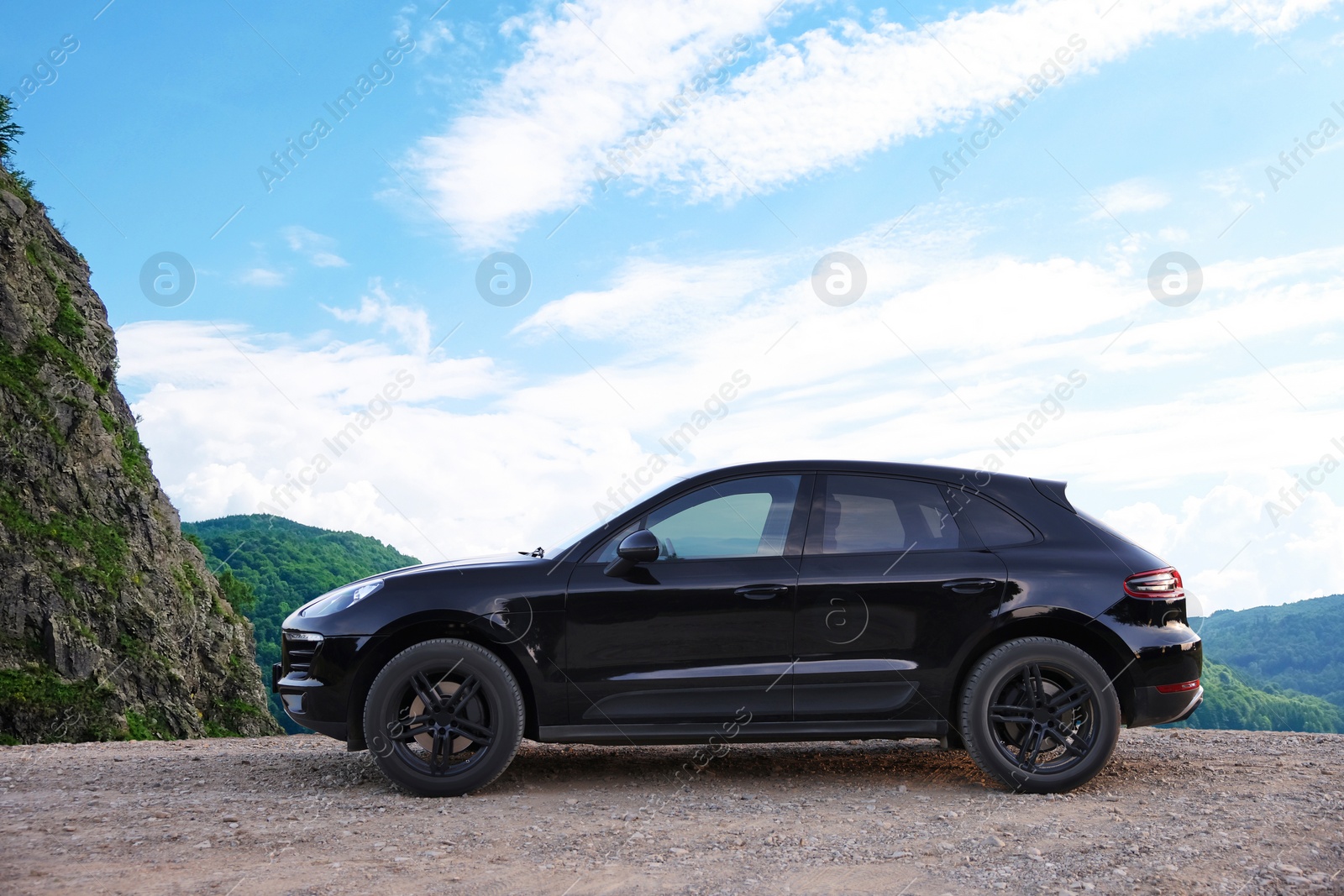Image of Stylish modern car on road in mountains