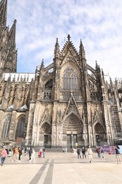 Photo of Cologne, Germany - August 28, 2022: Beautiful old gothic cathedral on city street
