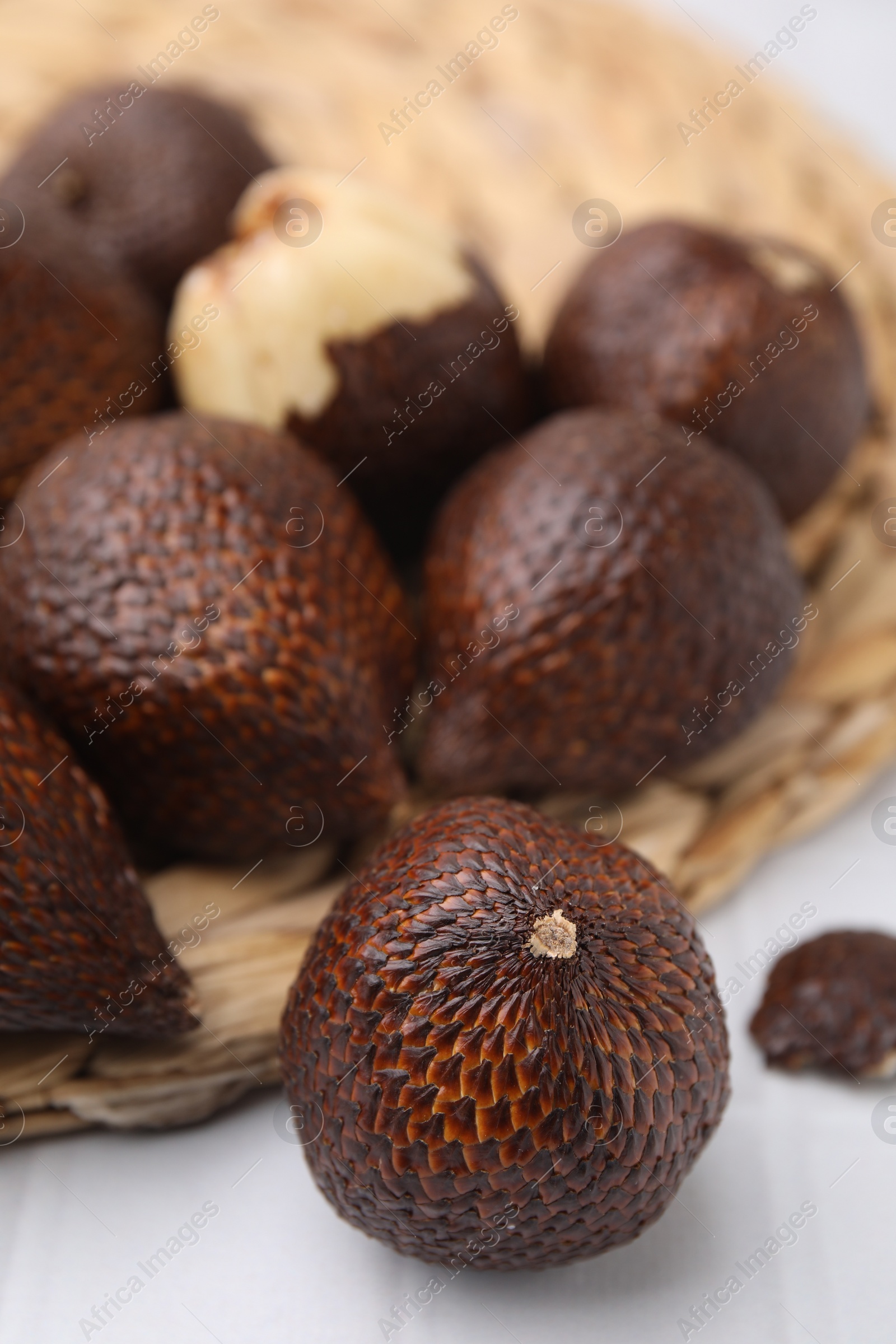 Photo of Many fresh salak fruits on white table, closeup