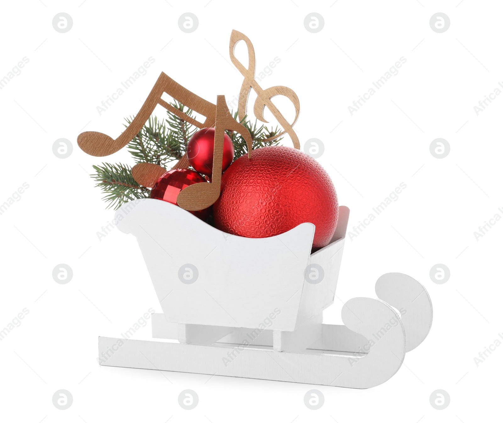 Photo of Decorative sleigh with wooden music notes and Christmas balls in sleigh isolated on white