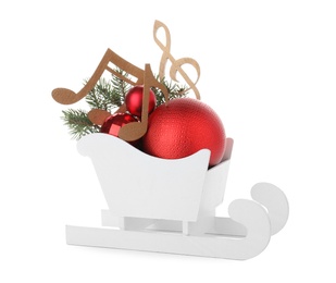 Decorative sleigh with wooden music notes and Christmas balls in sleigh isolated on white