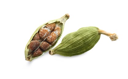 Photo of Dry green cardamom pods on white background, top view