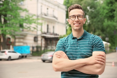 Photo of Portrait of attractive young man in stylish outfit outdoors