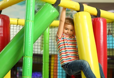 Cute little child playing at indoor amusement park