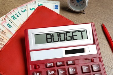 Image of Calculator with word Budget, notebook and money on table, closeup