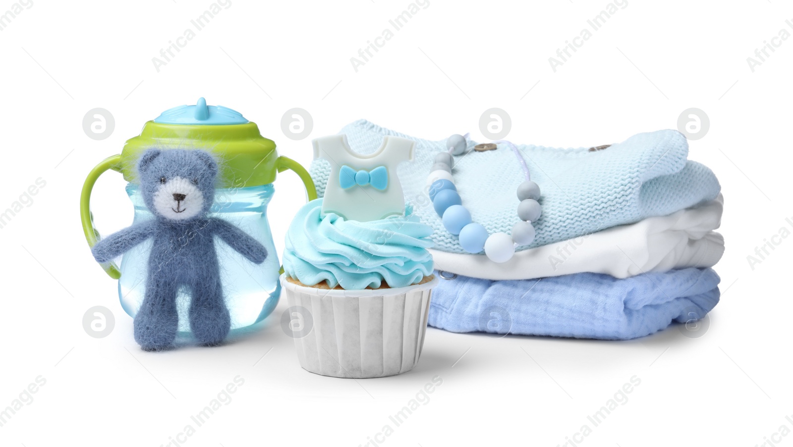 Photo of Beautifully decorated baby shower cupcake for boy, clothes and accessories on white background