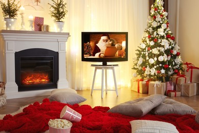 Image of Stylish living room interior with TV set, Christmas tree and fireplace