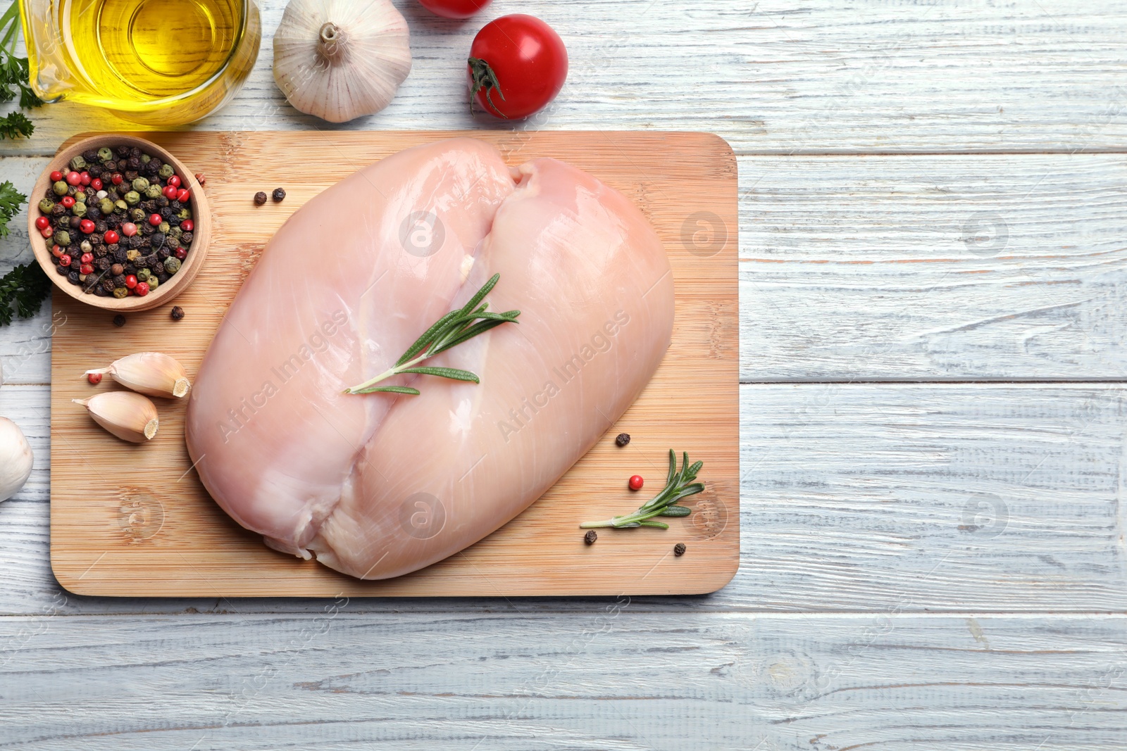 Photo of Flat lay composition with raw chicken breasts and ingredients on wooden background. Space for text