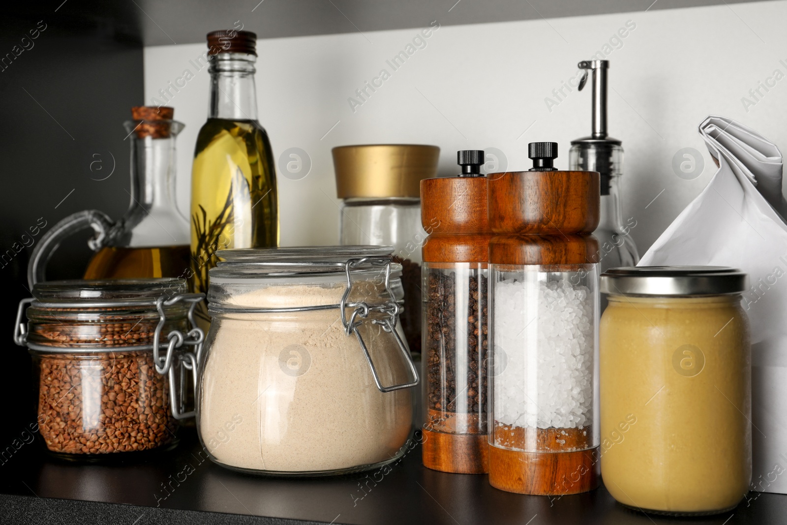 Photo of Flour and buckwheat in glass jars on shelf