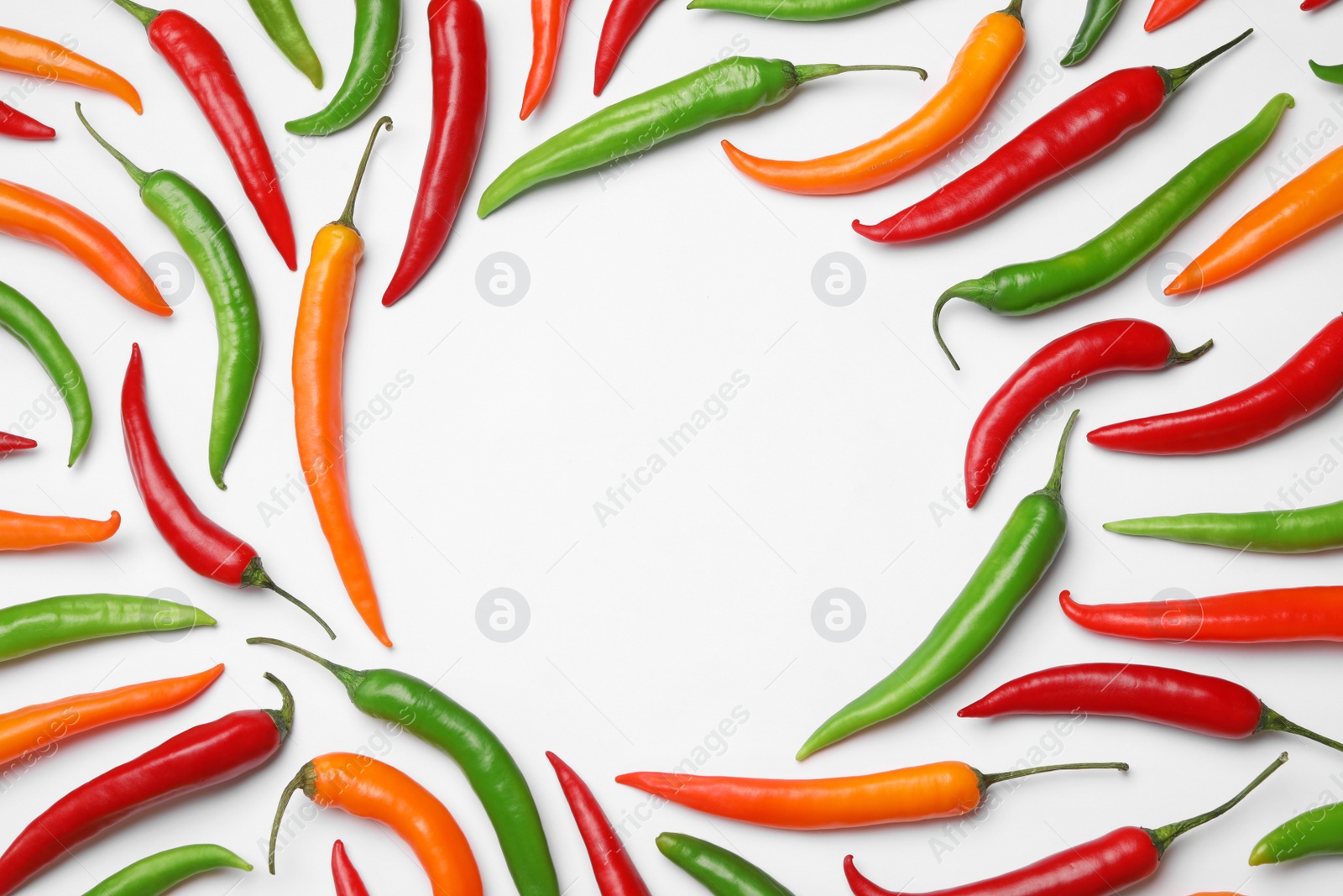 Photo of Frame made with different chili peppers on white background, top view. Space for text