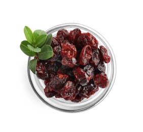 Tasty dried cranberries and leaves in bowl isolated on white, top view