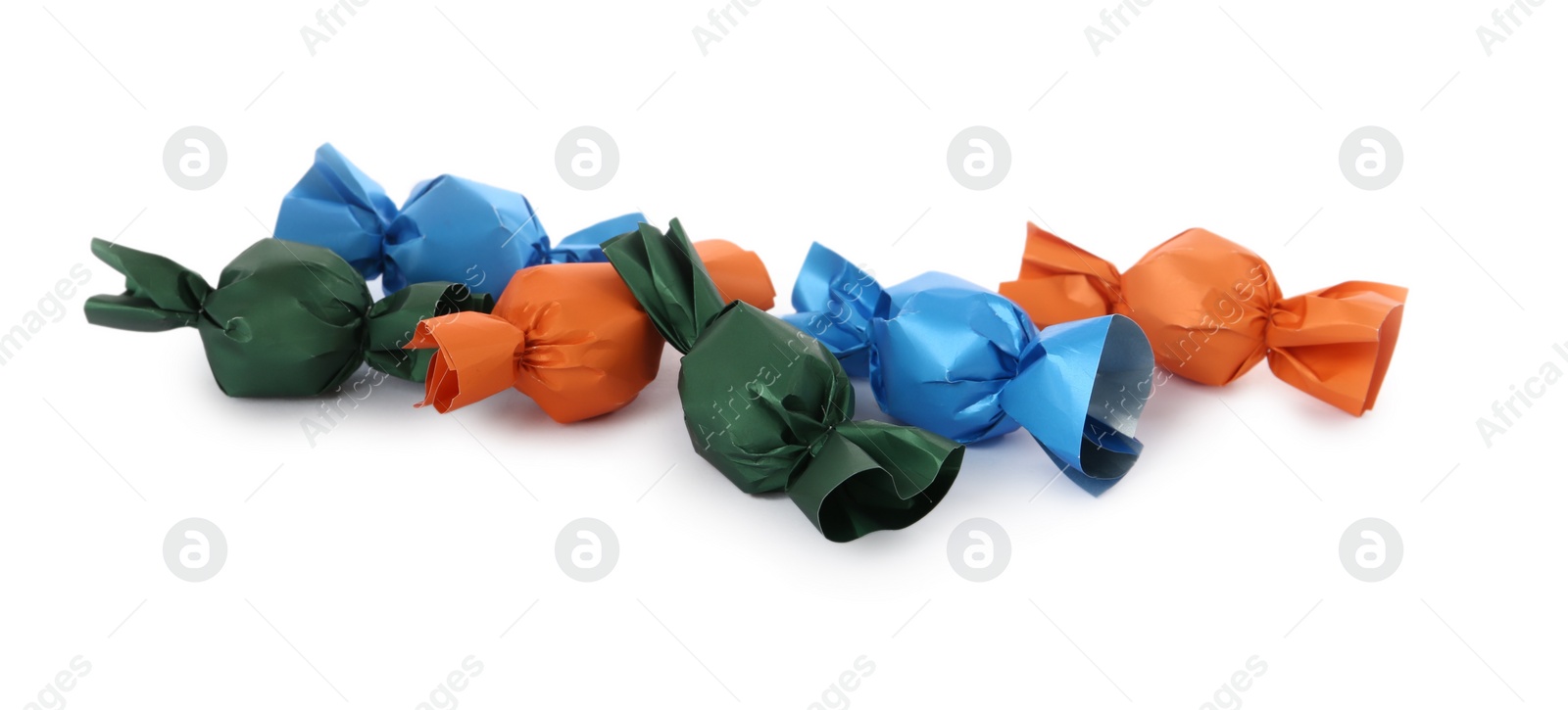 Photo of Many candies in colorful wrappers on white background