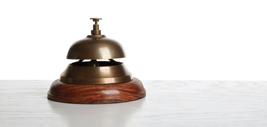 Photo of Hotel service bell on light table against white background