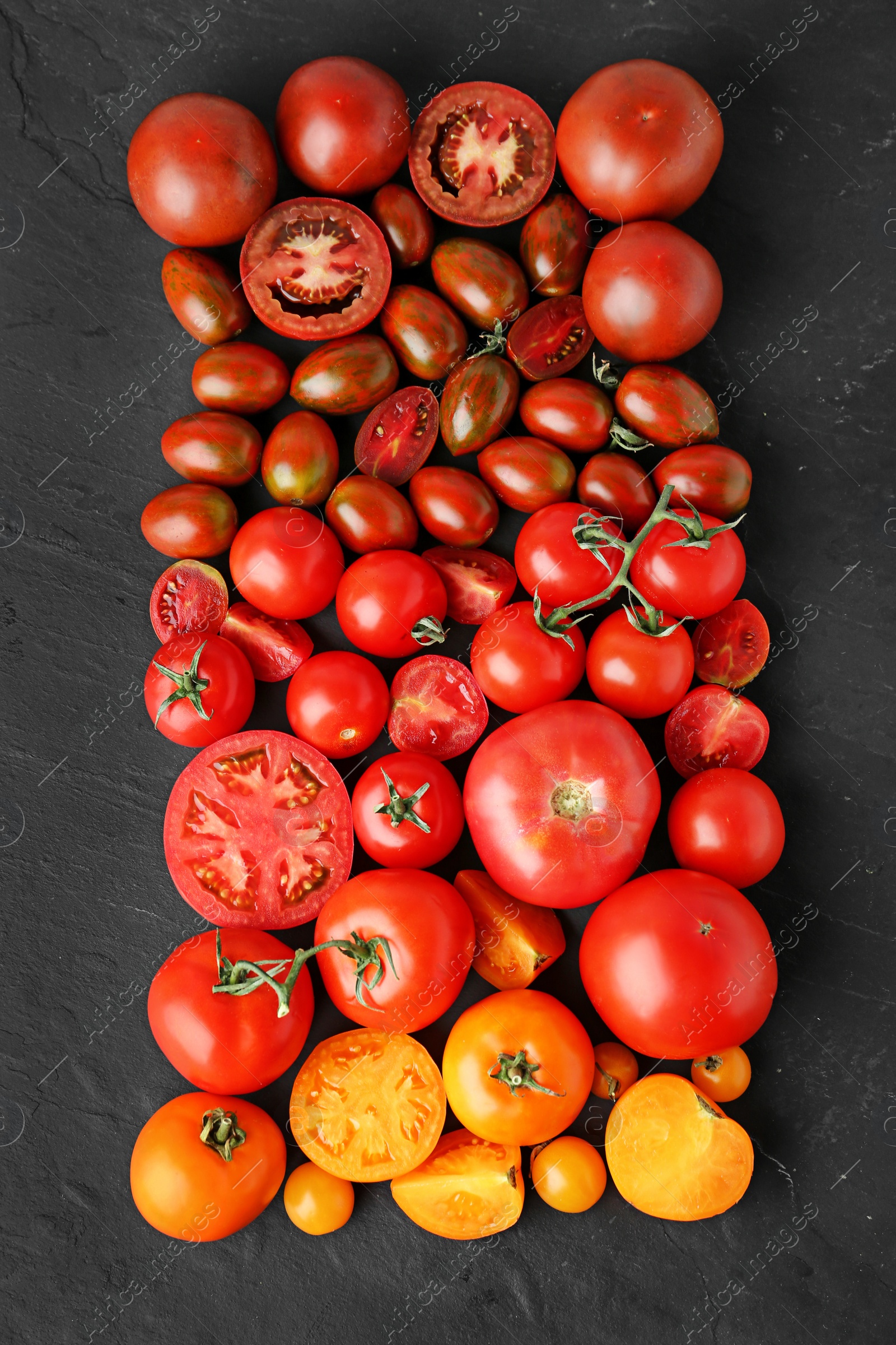 Photo of Flat lay composition with fresh ripe tomatoes on black background