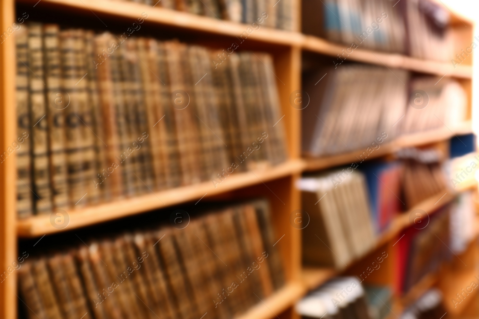 Photo of Blurred view of books on shelves in library