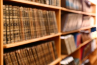 Blurred view of books on shelves in library