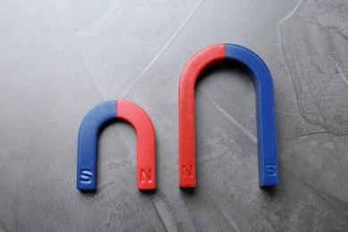 Photo of Red and blue horseshoe magnets on grey background