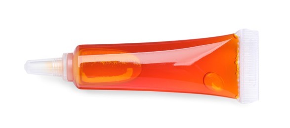 Photo of Tube with orange food coloring isolated on white, top view