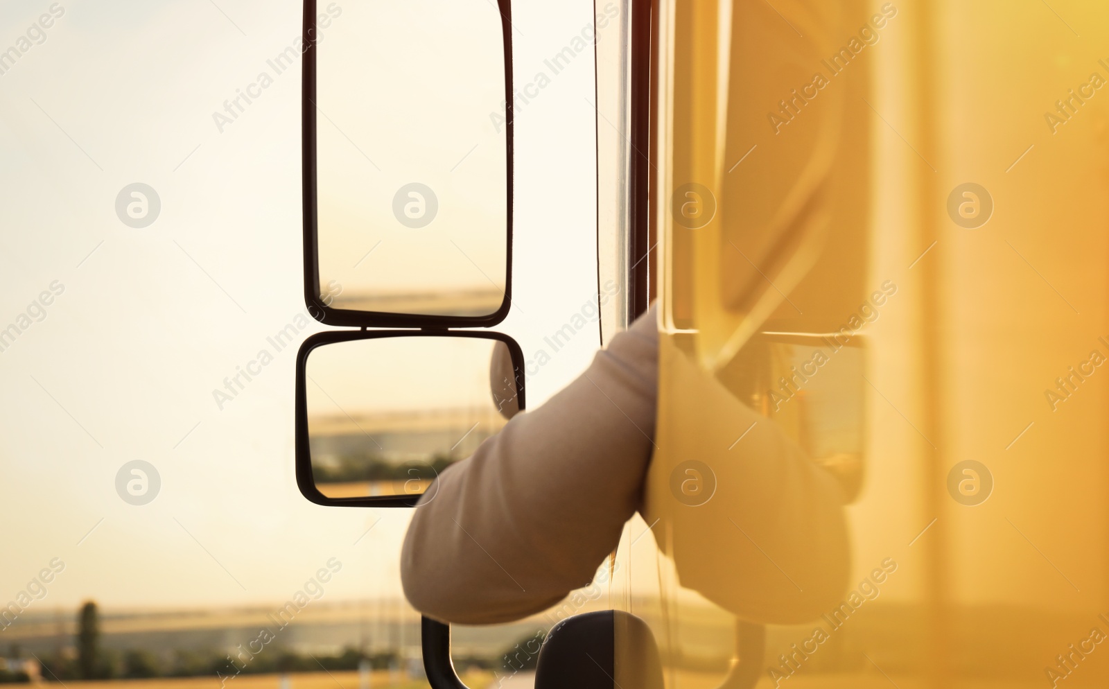 Photo of Man driving modern truck on country road