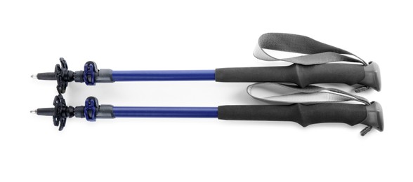 Photo of Pair of trekking poles on white background, top view. Camping tourism
