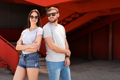 Photo of Young couple wearing gray t-shirts on street