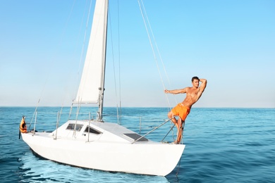 Young man relaxing on yacht during sea trip