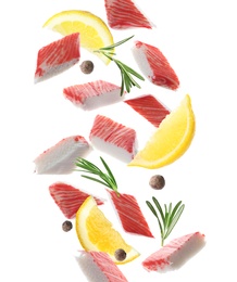 Cut fresh crab sticks, lemon, rosemary and allspice falling on white background