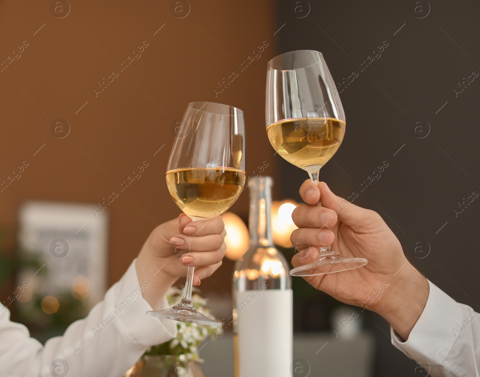 Photo of Young couple with glasses of delicious wine in restaurant