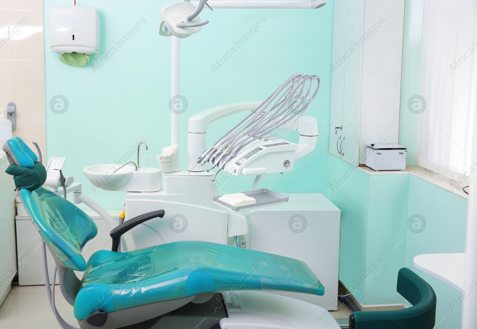 Photo of Dentist's office with modern chair and professional equipment