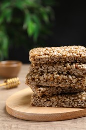 Photo of Delicious sweet kozinaki bars on wooden table