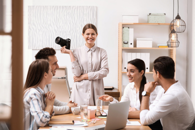 Photo of Team of professional journalists working in office