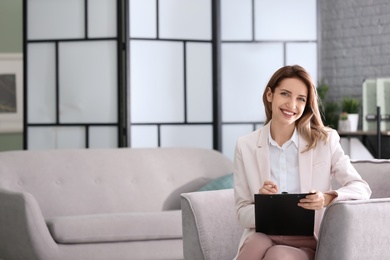 Photo of Young female psychologist in office