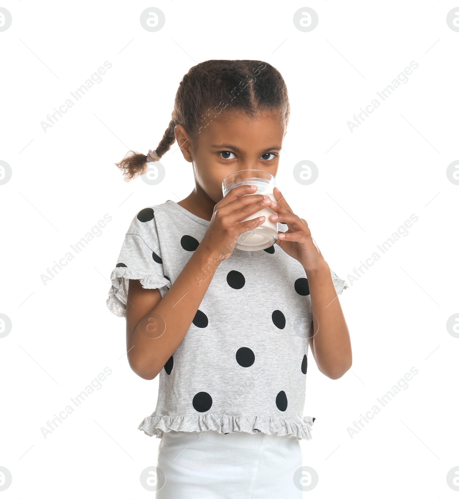 Photo of Adorable African-American girl with glass of milk on white background