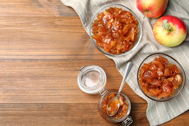 Photo of Tasty apple jam and fresh fruits on wooden table, flat lay, space for text