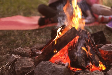 Photo of Small bonfire burning bright outdoors. Summer camp