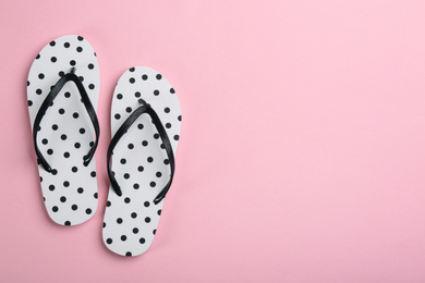 Stylish flip flops on pink background, flat lay. Space for text