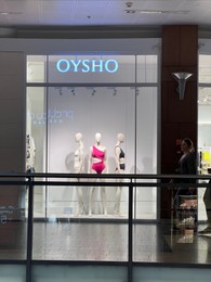 Photo of WARSAW, POLAND - JULY 17, 2022: Oysho store display with women swimwear on mannequins in shopping mall