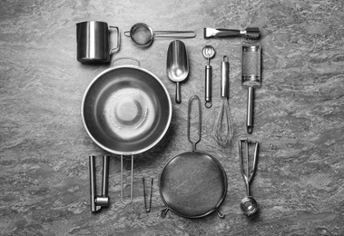 Photo of Set of cooking utensils on grey table, flat lay