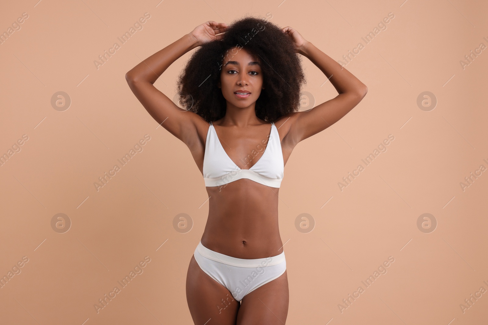 Photo of Beautiful woman in stylish bikini on beige background