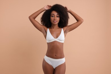 Beautiful woman in stylish bikini on beige background