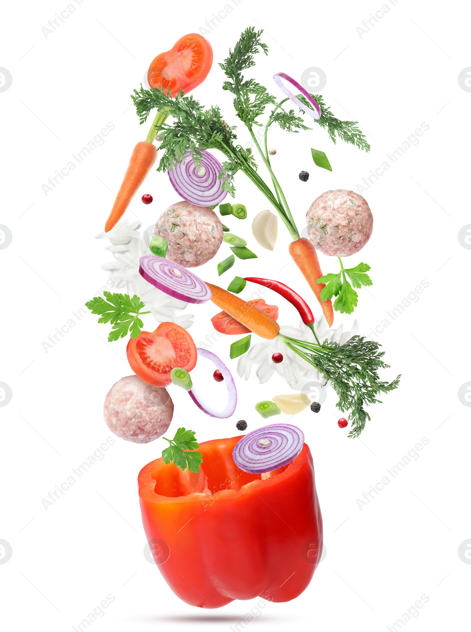 Image of Stuffed pepper recipe. Fresh ingredients falling into bell pepper on white background