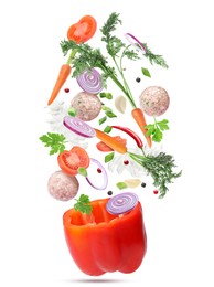 Image of Stuffed pepper recipe. Fresh ingredients falling into bell pepper on white background