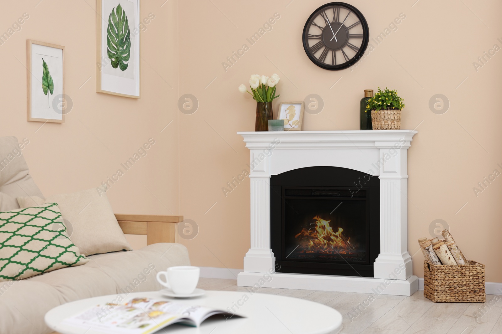 Photo of Stylish fireplace near comfortable sofa and coffee table in cosy living room