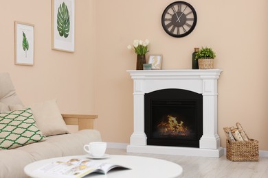 Photo of Stylish fireplace near comfortable sofa and coffee table in cosy living room