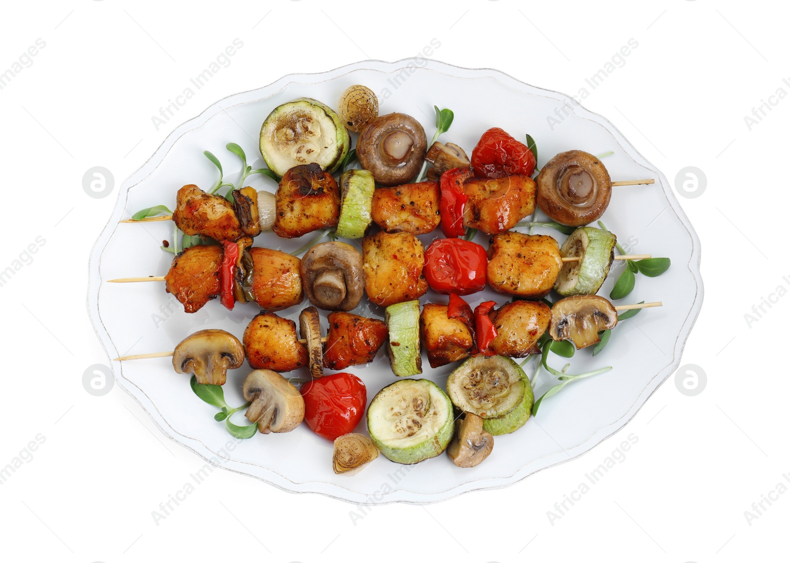 Photo of Delicious shish kebabs with vegetables and microgreens isolated on white, top view