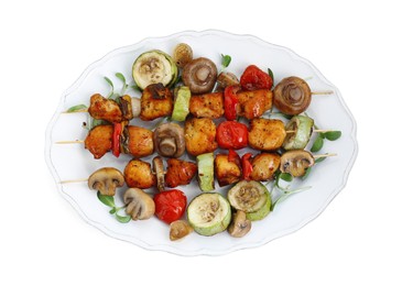Photo of Delicious shish kebabs with vegetables and microgreens isolated on white, top view
