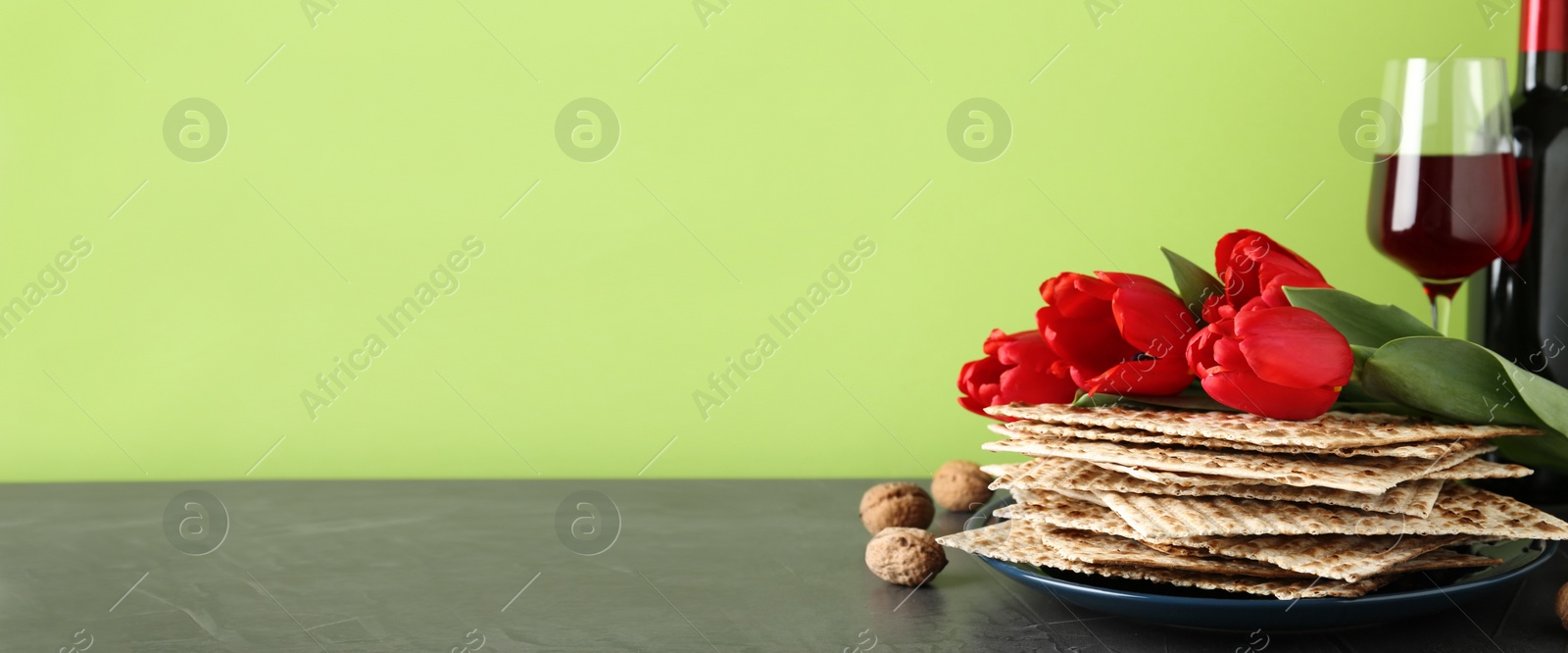 Image of Composition with Passover matzos on green background, space for text. Pesach celebration