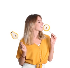 Young pretty woman with candies on white background